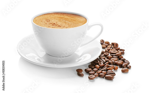 A cup of tasty drink and scattered coffee grains, isolated on white