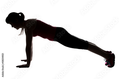 Silhouette of sporty woman doing bar 