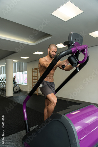 Young Man Exercising On A Stepper