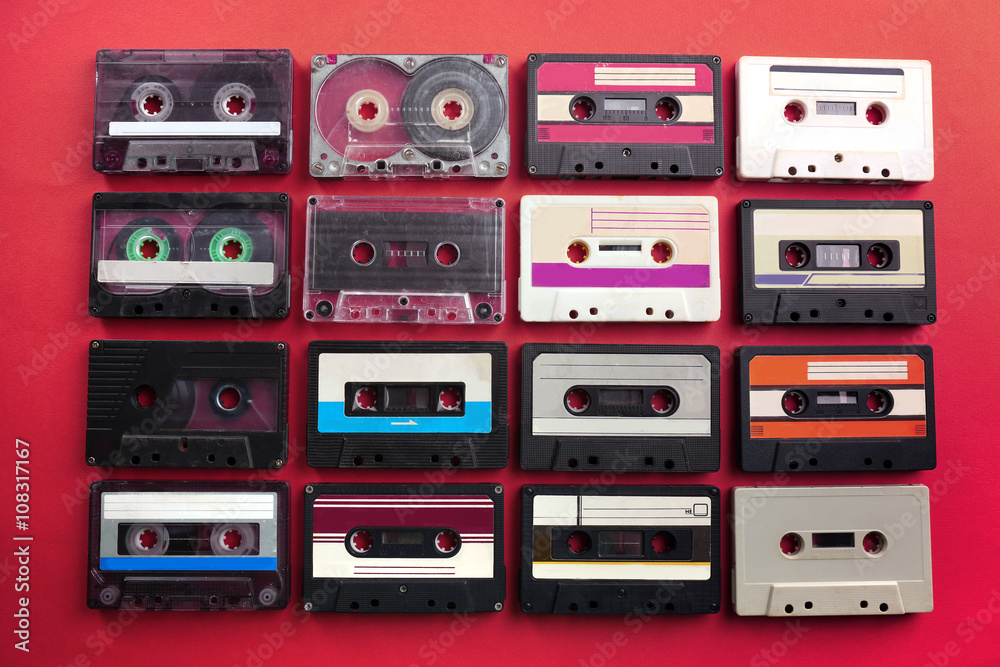 Set of old audio cassettes on red background Set of old audio cassettes on red background