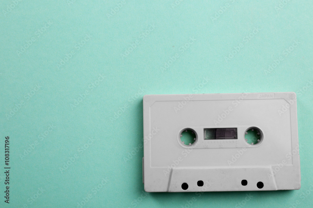 Fototapeta premium Old audio cassette on turquoise background