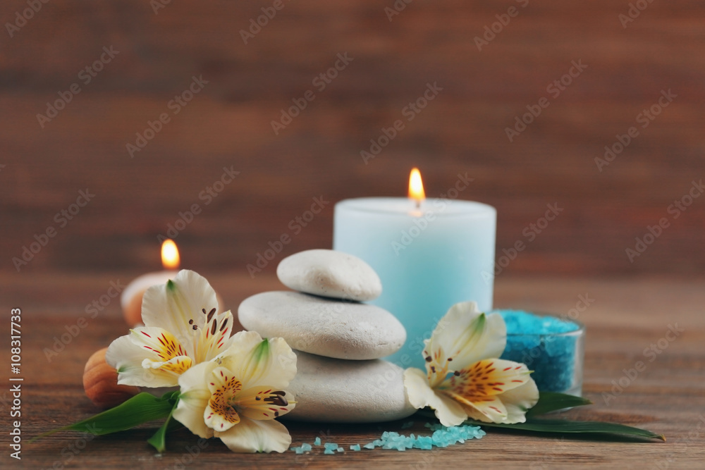 Spa still life with light blue candle on wooden background