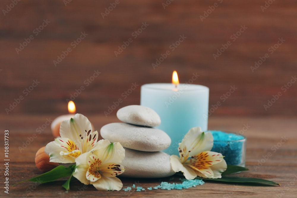 Spa still life with light blue candle on wooden background Spa still life with light blue candle on wooden background