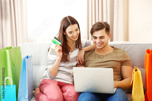 Young couple sitting on sof...