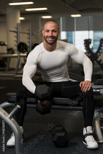 Young Healthy Man Doing Exercise For Biceps