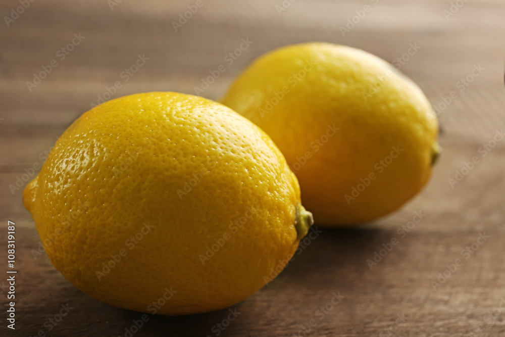 Fresh lemons on wooden background