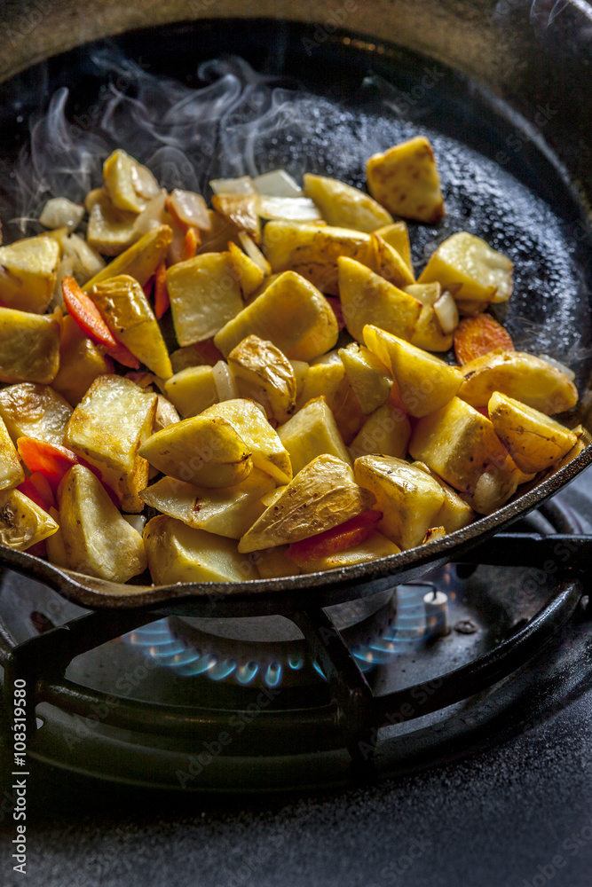 Frying up potatoes in a skillet. Frying up potatoes in a skillet.
