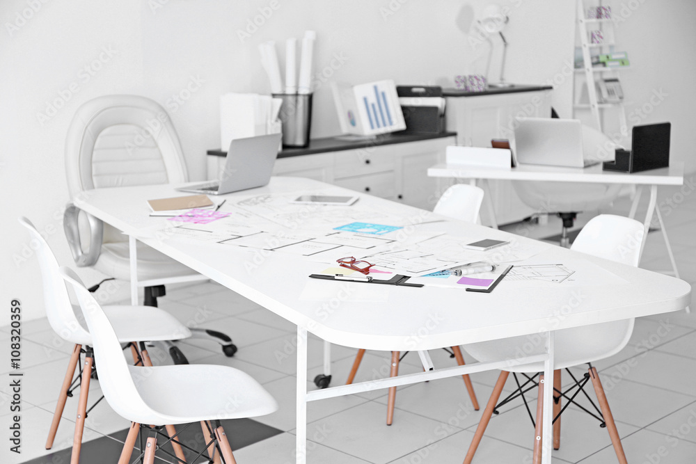 Table of architect with drafts and clipboard in the office Table of architect with drafts and clipboard in the office