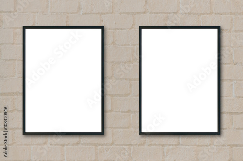 Mock up blank poster picture frame on brick wall.