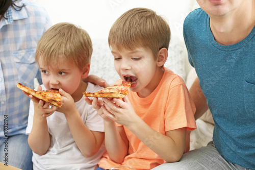 Little kids eating pizza, close up