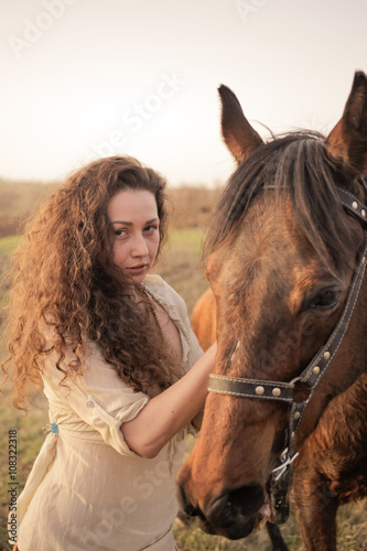 Beautiful girl with a horse outdoors in the countryside. © trek6500
