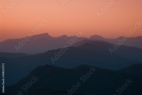 Sunrise in the mountains with mountains silhouette