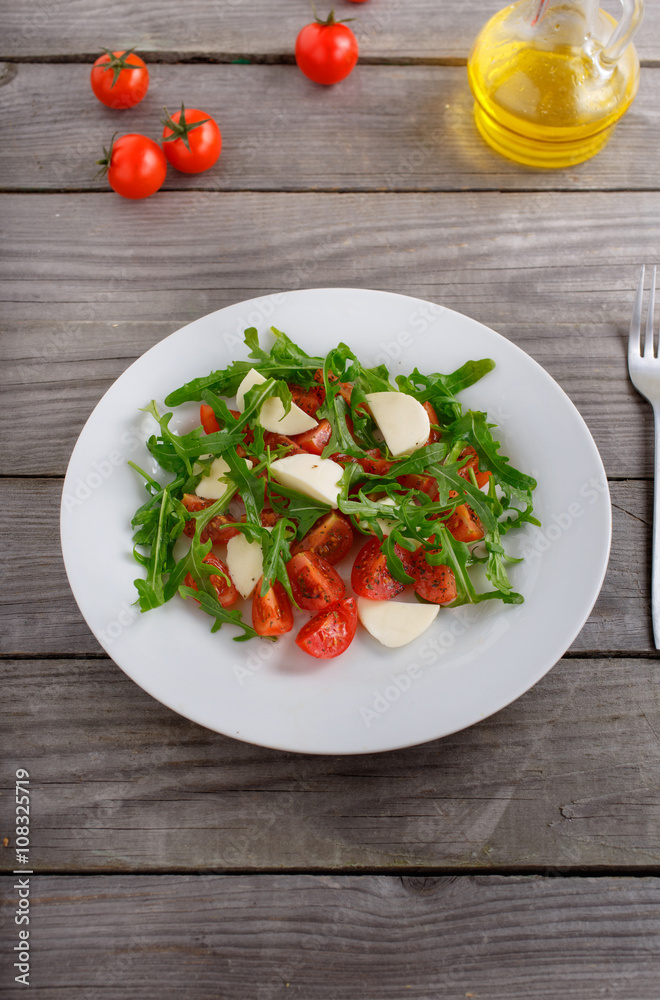 salad of arugula, tomato and mozzarella salad of arugula, tomato and mozzarella