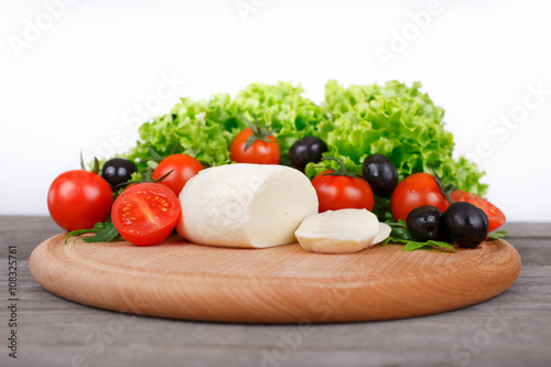 mozzarella with cherry tomatoes, arugula, lettuce leaves and bla