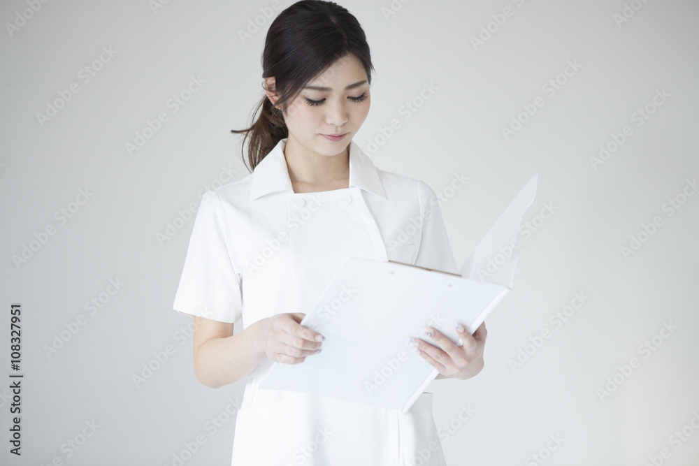 Female nurse looking at a chart
