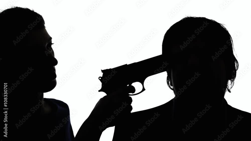 A woman pointing a handgun to a man's temple. Crime, violence, robbery. Silhouette shot. A woman pointing a handgun to a man's temple. Crime, violence, robbery. Silhouette shot.