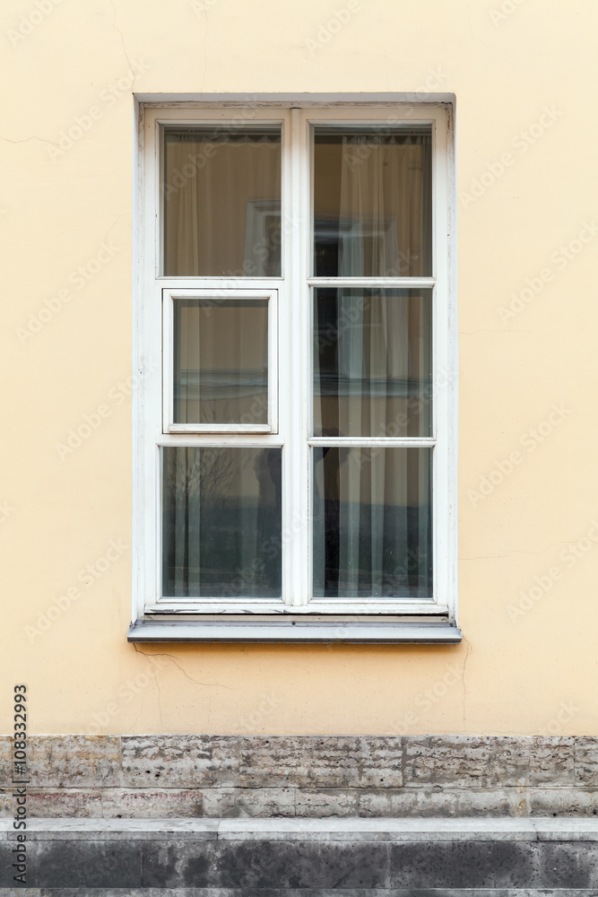Yellow wall and window in white frame