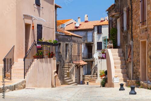 Narrow street of Piana town. Corsica, France photo