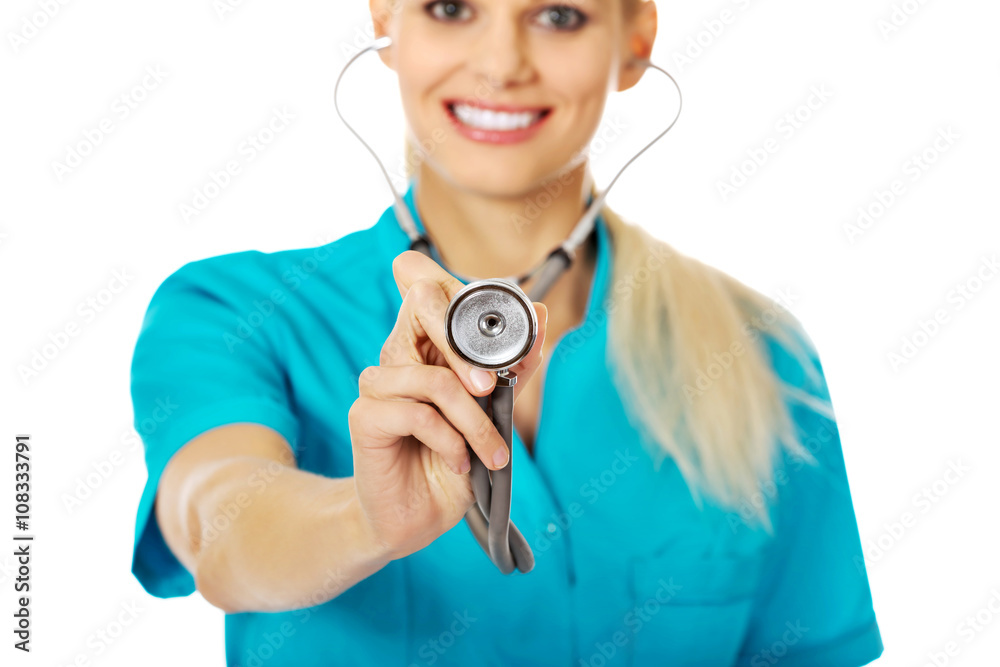 Smile female doctor or nurse uses stethoscope Smile female doctor or nurse uses stethoscope