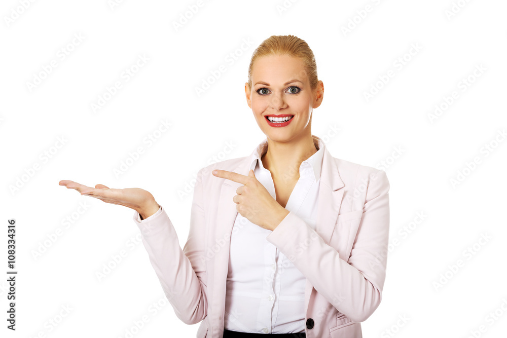 Business woman presenting something on open palm Business woman presenting something on open palm