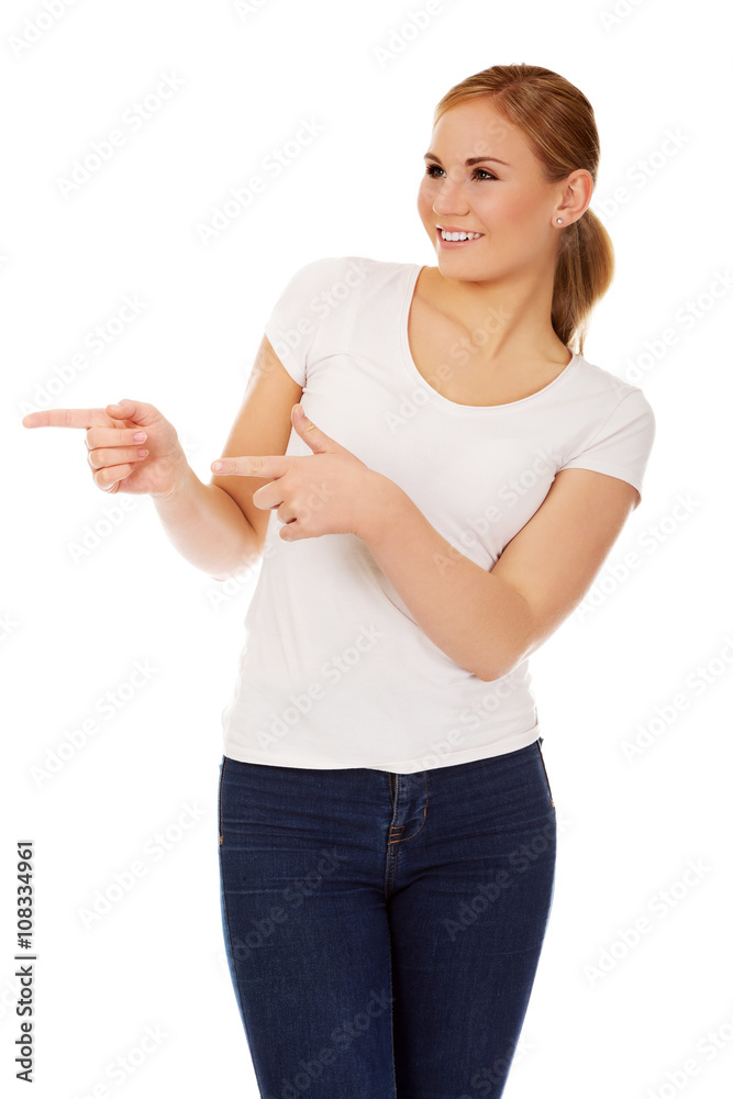 Young happy woman pointing for copyspace or something Young happy woman pointing for copyspace or something