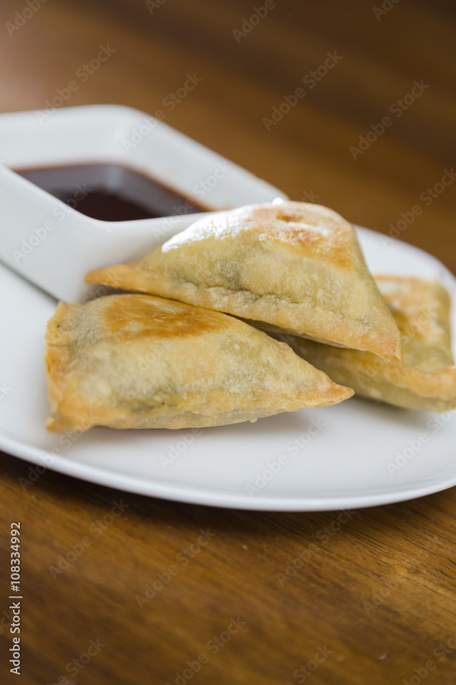 Samosas and Dipping Sauce Plate Closeup Samosas and Dipping Sauce Plate Closeup