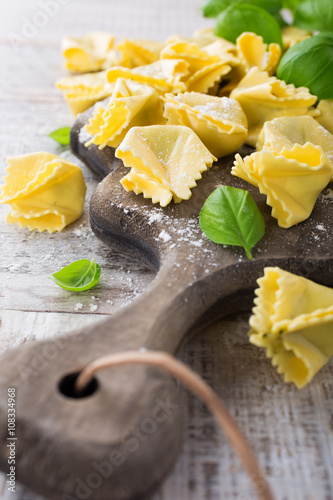 Homemade raw Italian saccottini with green pesto photo