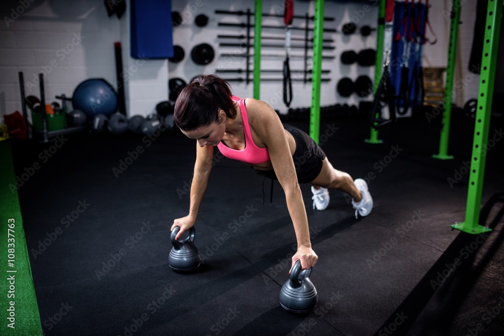 Woman exercising with kettlebell Woman exercising with kettlebell