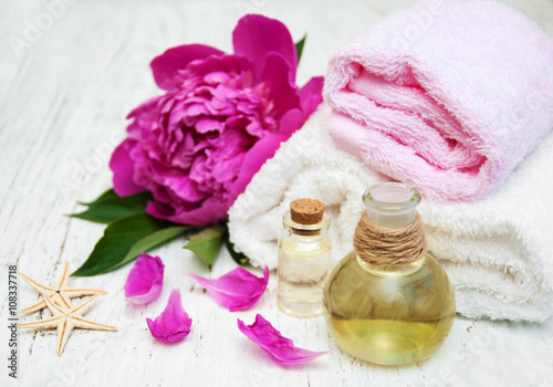 Peony flowers, massage oils and towels