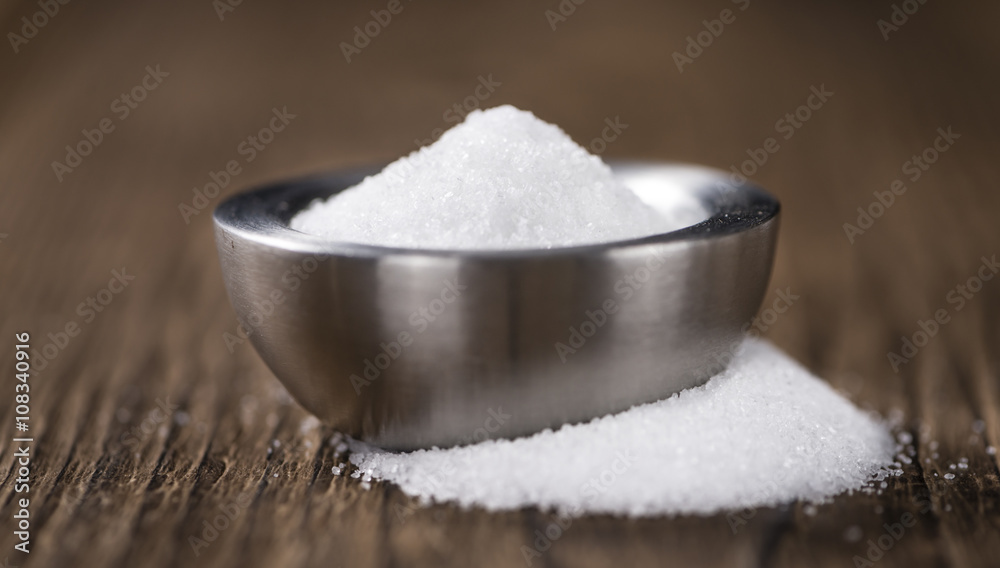 White Sugar (selective focus) on wooden background White Sugar (selective focus) on wooden background
