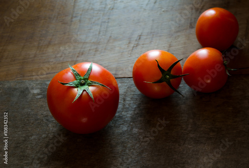 Tomato on wood dark tone background