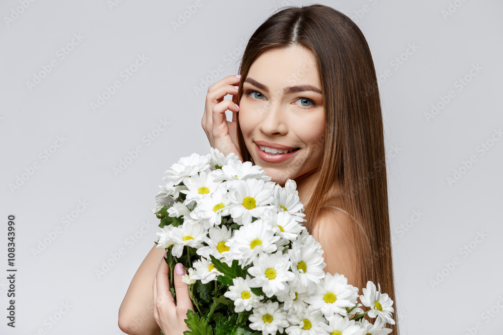 Beautiful Woman with Clean Fresh Skin holding flowers Beautiful Woman with Clean Fresh Skin holding flowers
