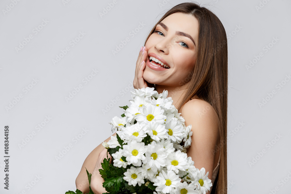 Beautiful Woman with Clean Fresh Skin holding flowers Beautiful Woman with Clean Fresh Skin holding flowers