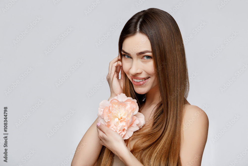 Beautiful Woman with Clean Fresh Skin holding flowers Beautiful Woman with Clean Fresh Skin holding flowers