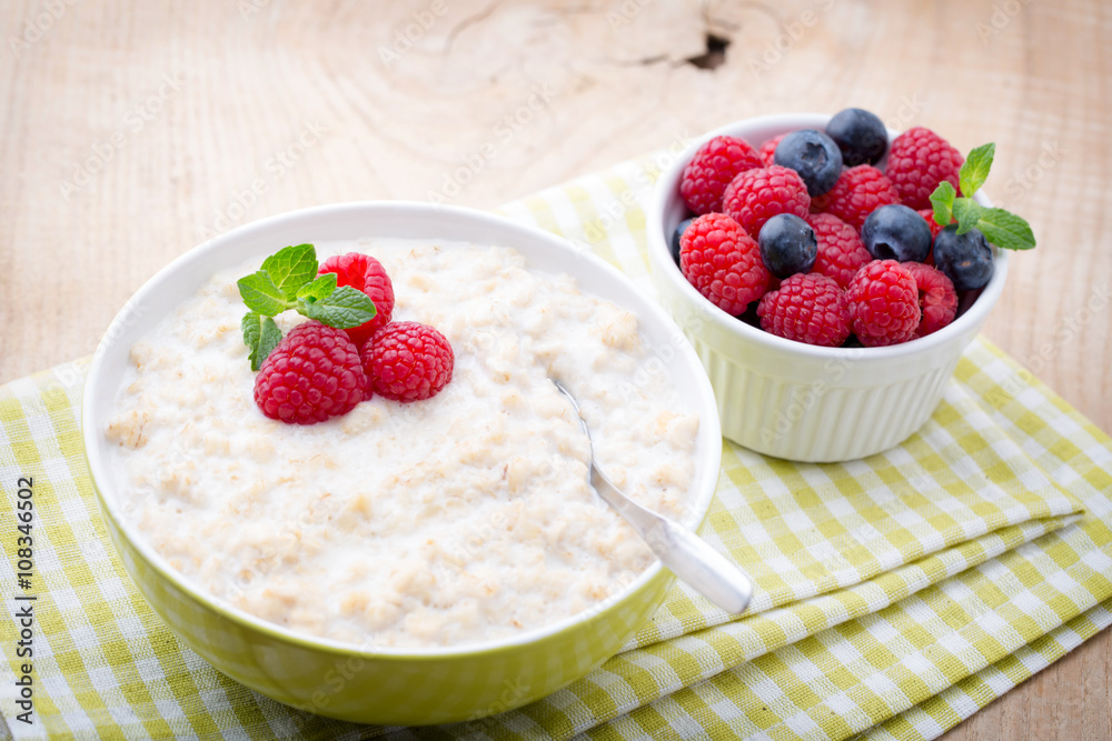 Oatmeal porridge in bowl with berries raspberries and blackberri Oatmeal porridge in bowl with berries raspberries and blackberri
