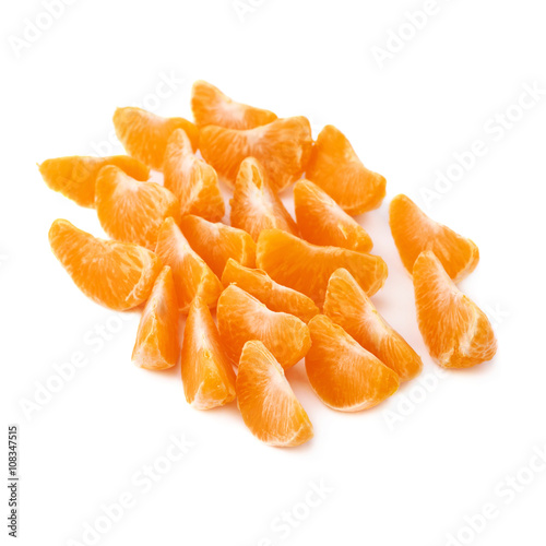 Surface covered with slice sections of tangerine isolated over the white background