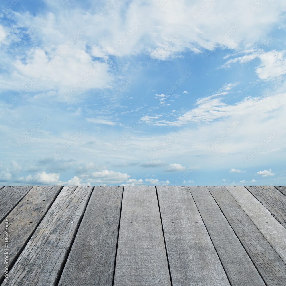 Empty old wood floor with blue sky with white clouds, for your p