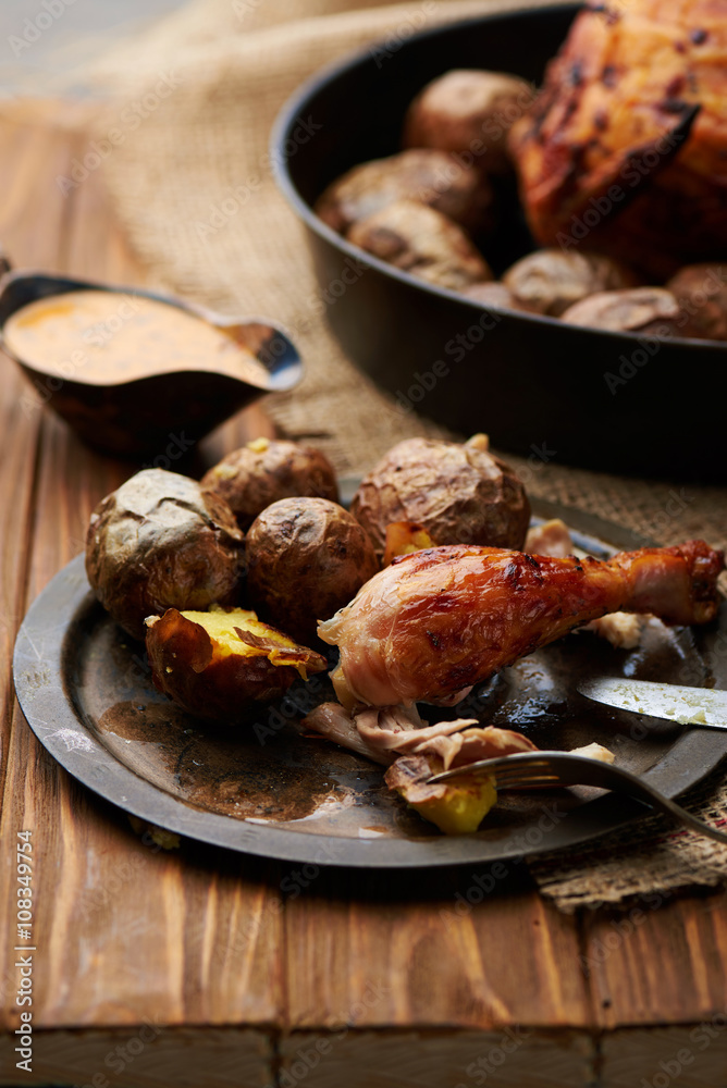 Barbecued chicken leg with baked potatoes
