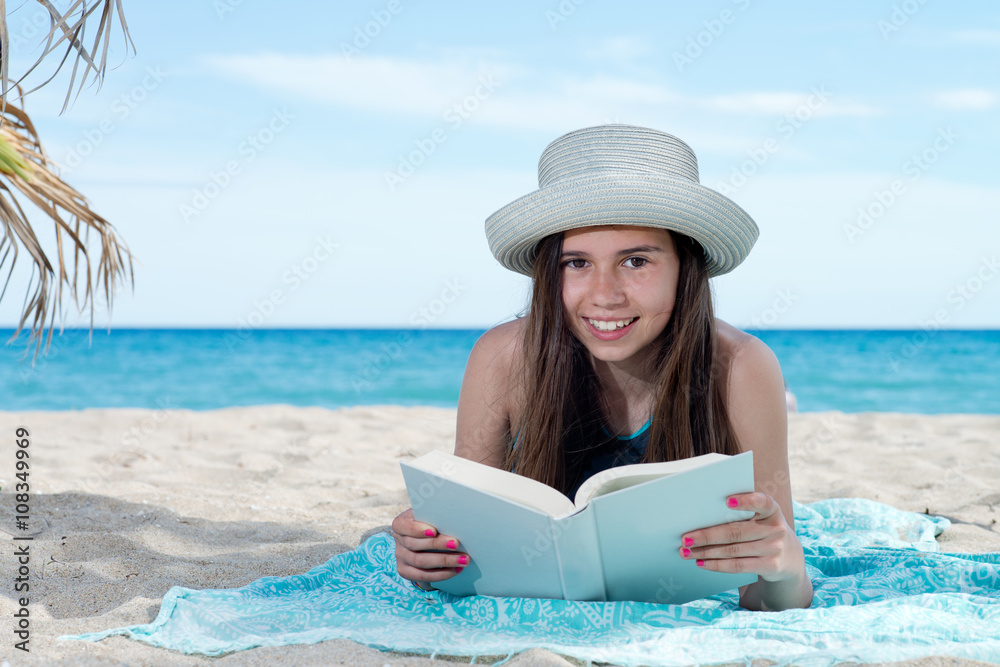 girl on the beach with book