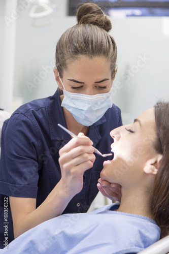 At the dentist. Female dentist in action