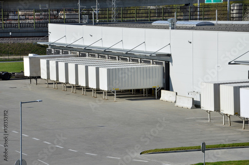 Cargo containers standing on gates in logistics center