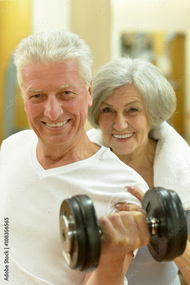 senior couple exercising in gym