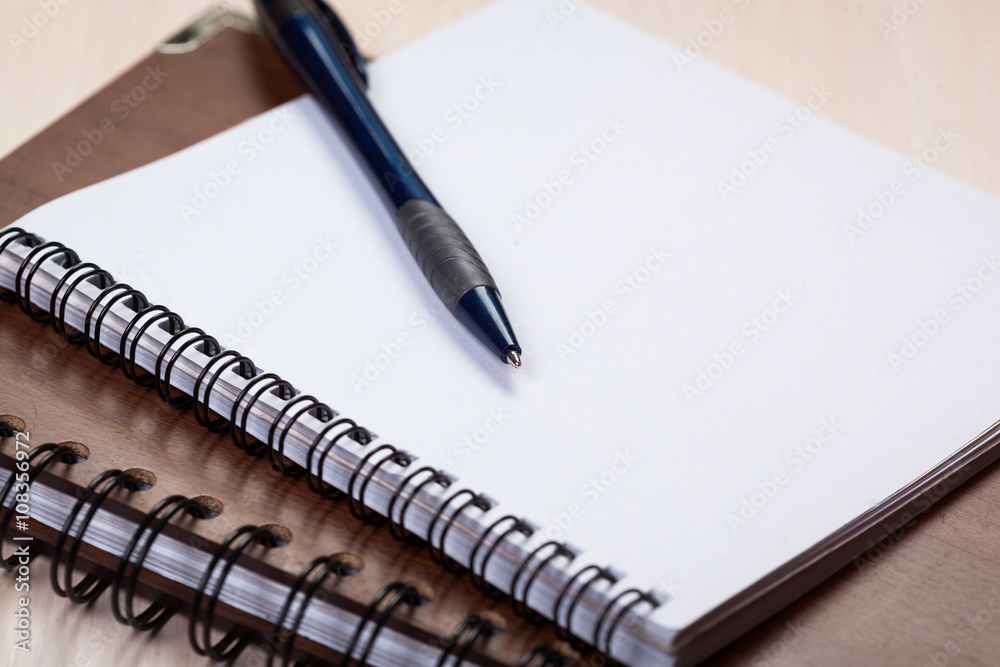 Blank note paper with pen on wood background Blank note paper with pen on wood background