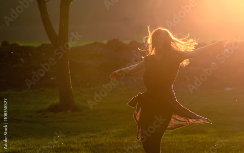 Teen girl jump against beautiful sunset © Laurentiu Iordache