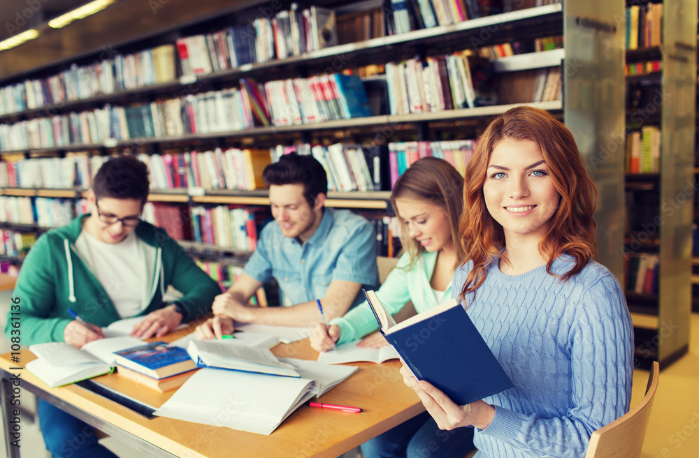 happy students reading books in library happy students reading books in library