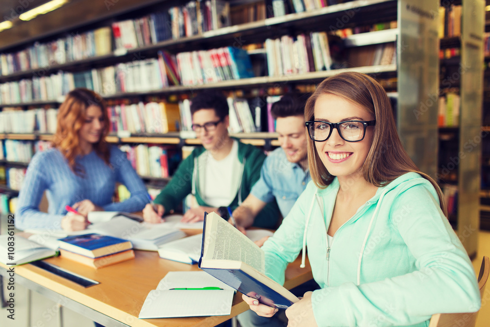 happy students reading books in library happy students reading books in library