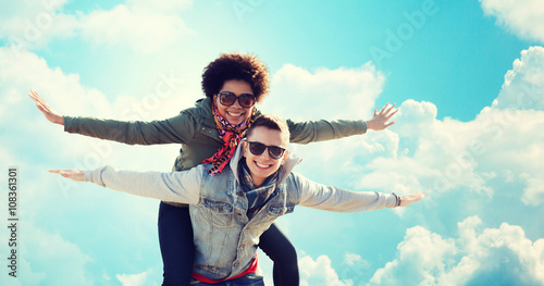 happy teenage couple in shades having fun outdoors