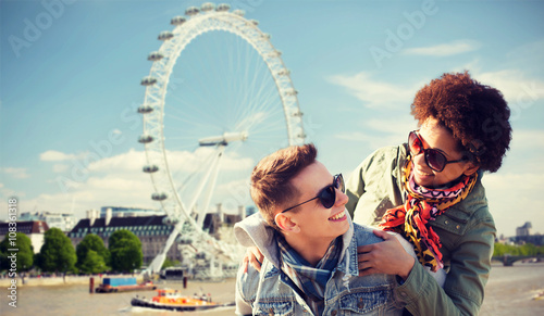 happy teenage couple having fun over london