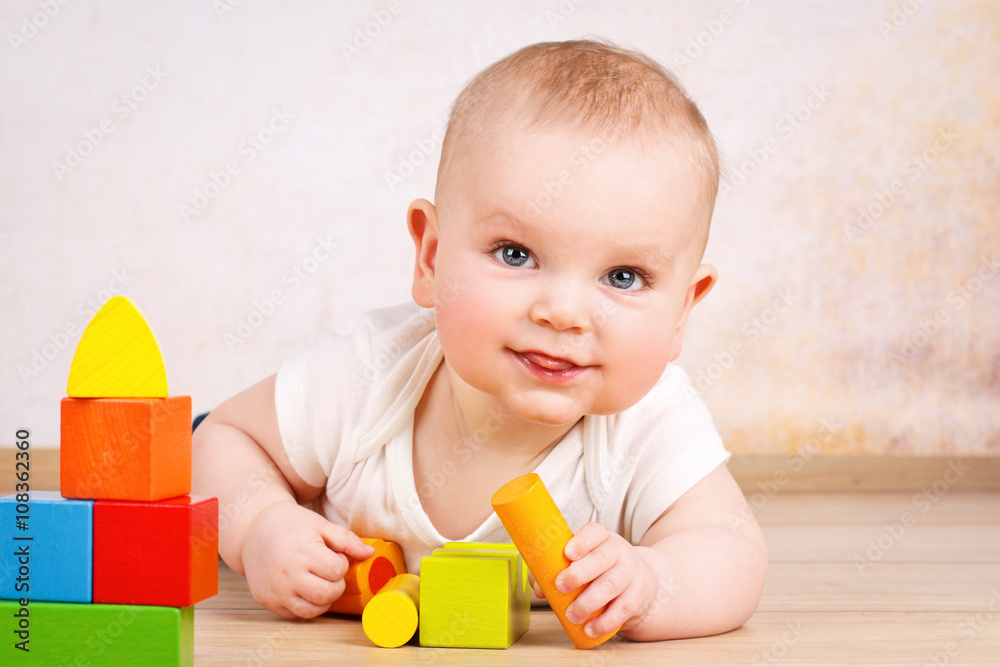 Cute toddler playing with wooden bricks Cute toddler playing with wooden bricks