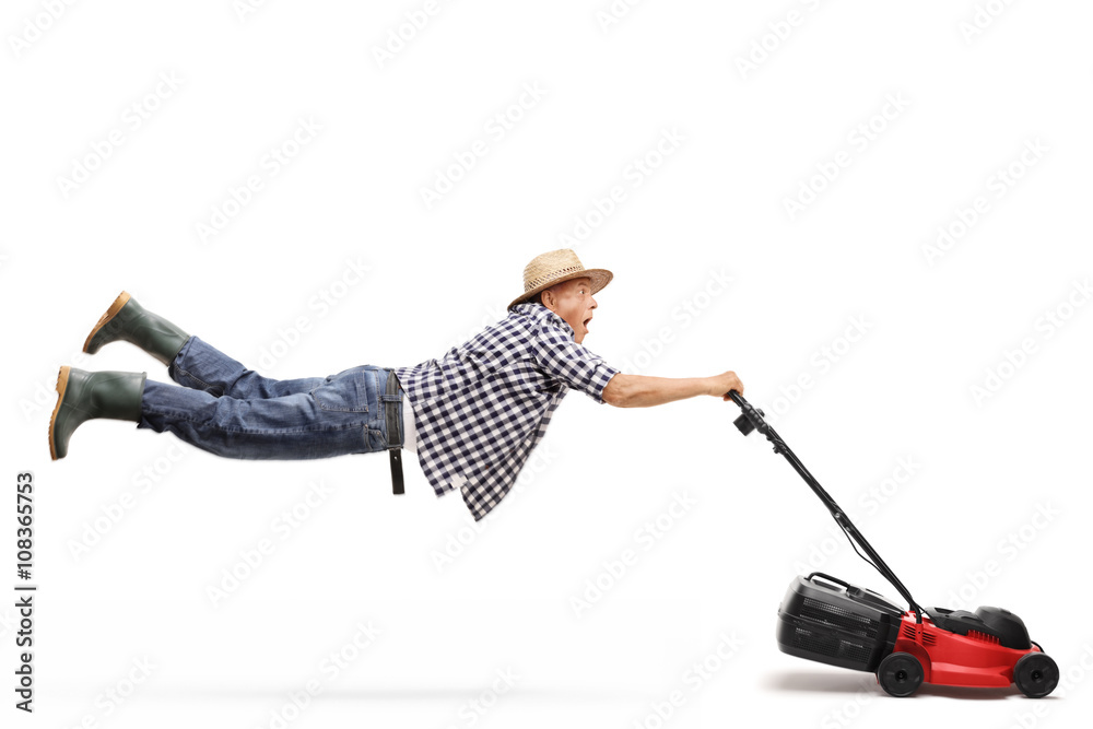 Mature gardener being pulled by a lawnmower Stock Photo Adobe Stock